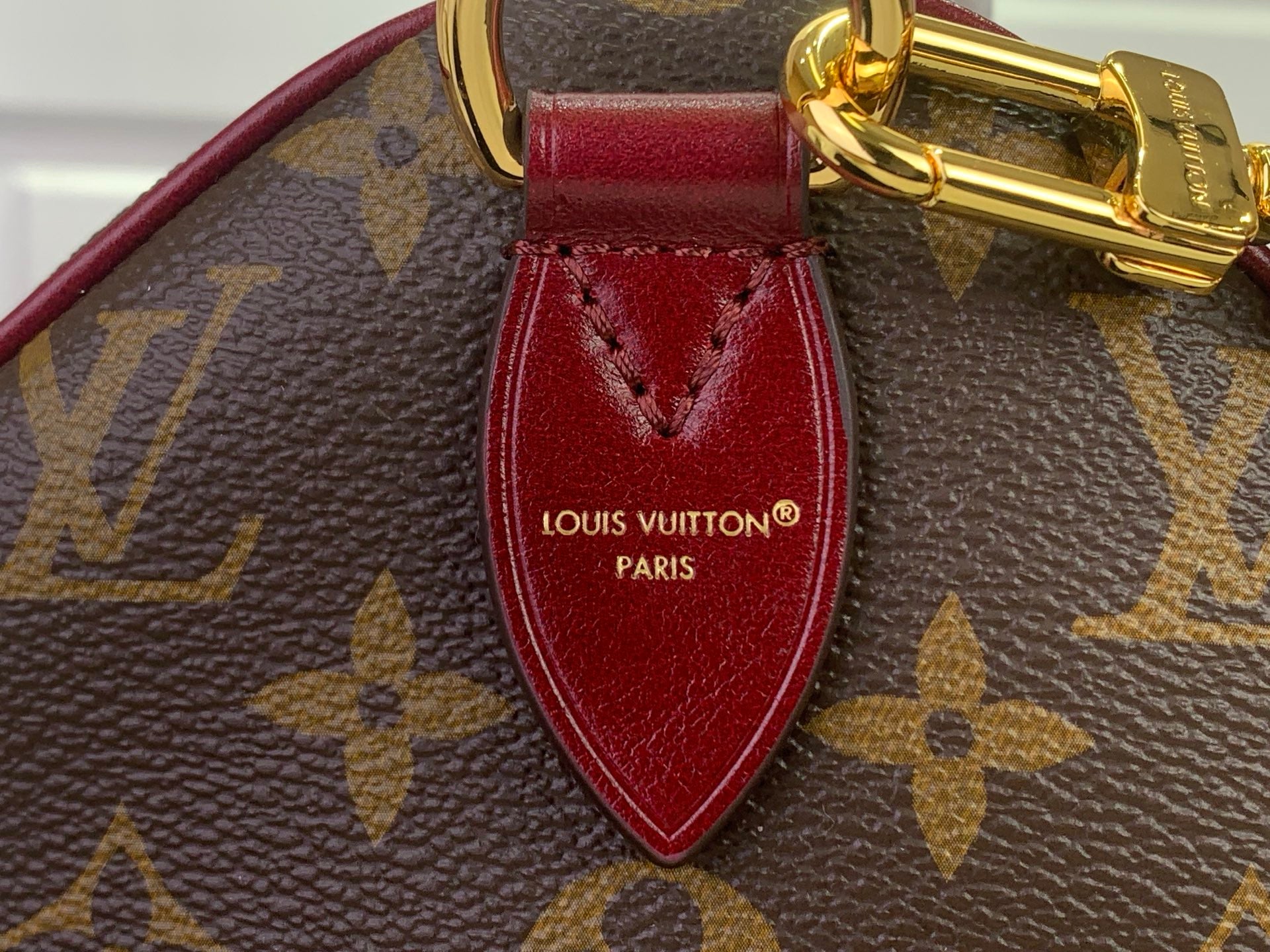 Louis Vuitton bag, red leather strap with gold clasp and LV Paris stamp