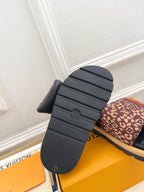 Brown monogram slide sandal with dark navy molded rubber sole detail