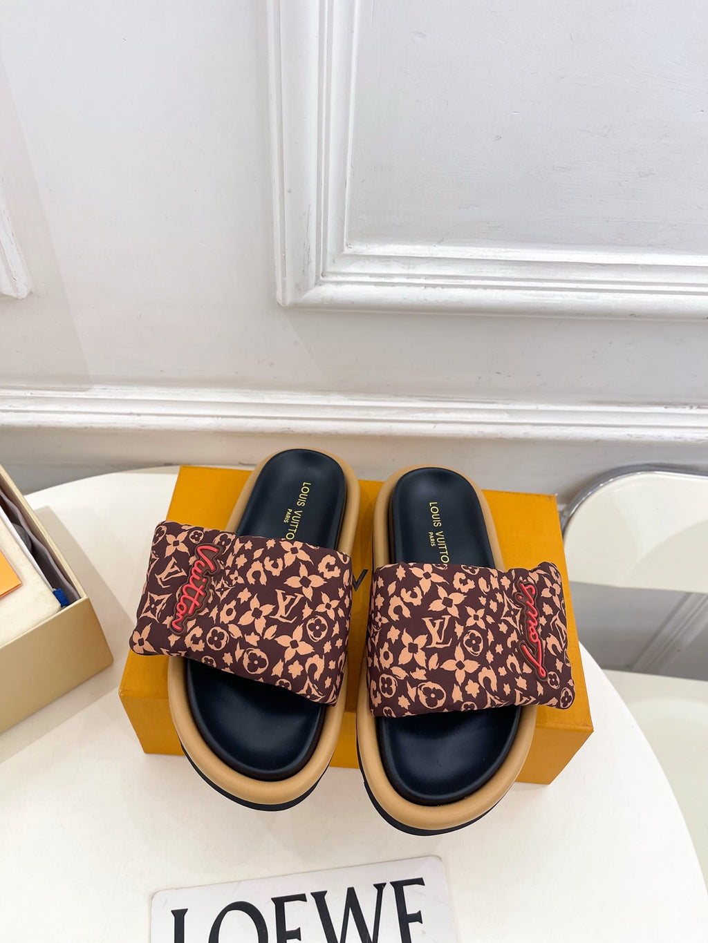 Brown monogram slide sandals with dark navy footbed and wide fabric band