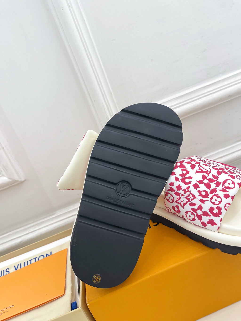 Louis Vuitton slide sandal outsole in dark rubber with white-red monogram strap