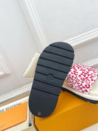 Louis Vuitton slide sandal outsole in dark rubber with white-red monogram strap