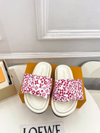 Louis Vuitton slide sandals with white straps and red monogram print