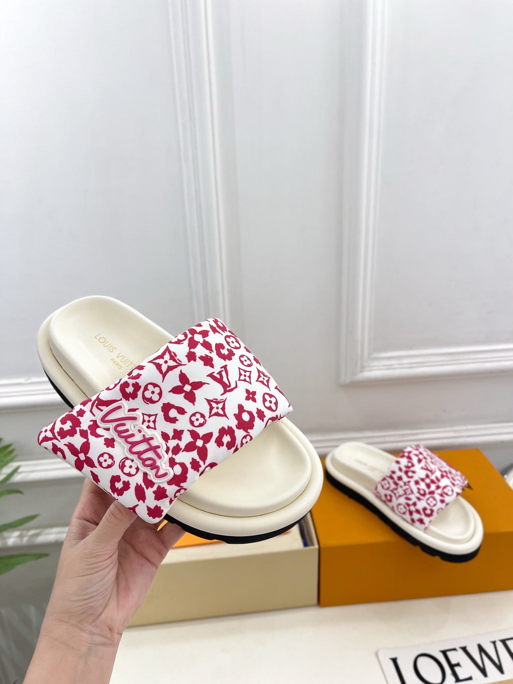 Louis Vuitton slide sandals with white footbeds and red monogram patterned straps
