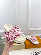 Louis Vuitton slide sandals with white footbeds and red monogram patterned straps