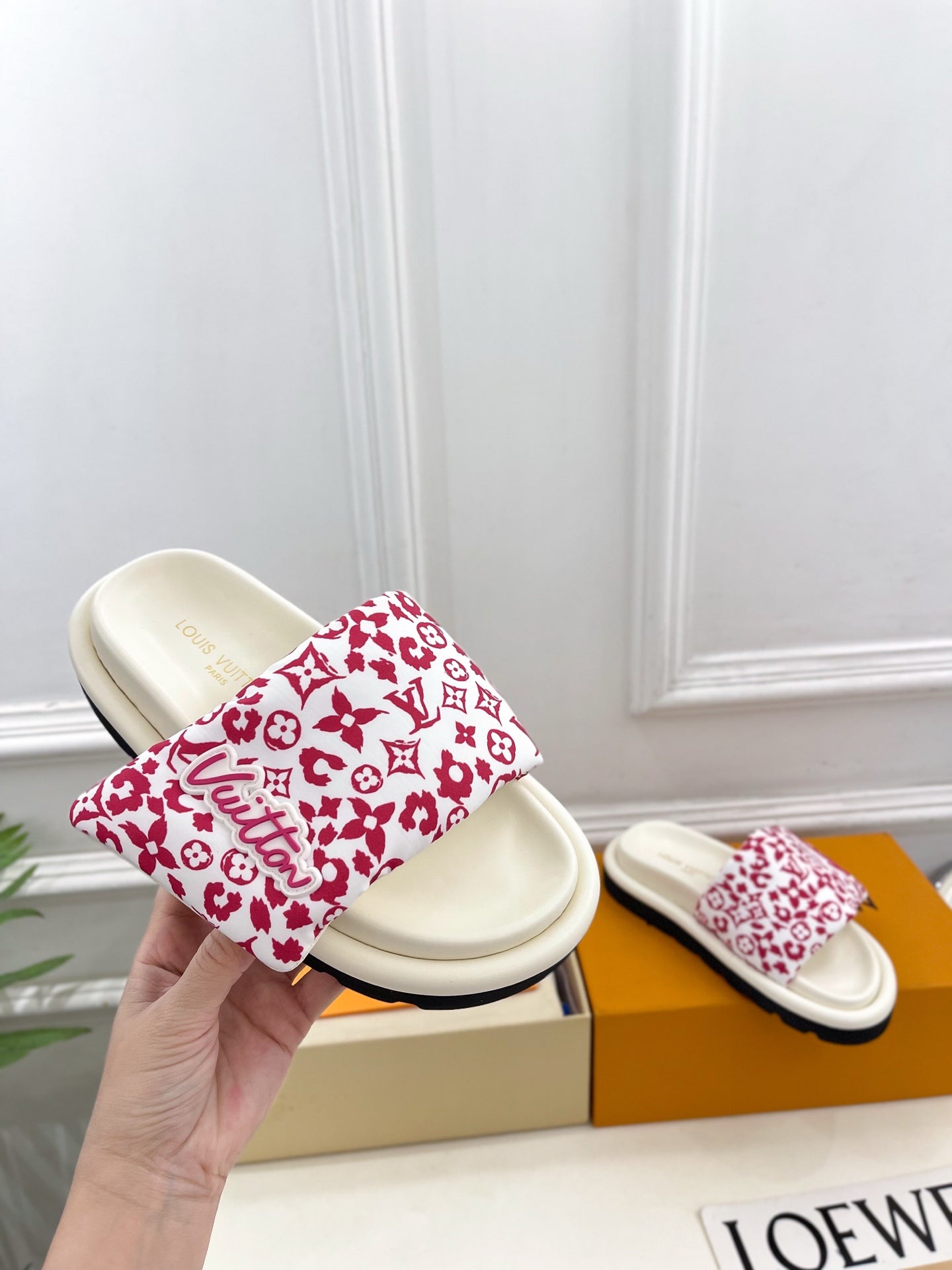 Louis Vuitton slide sandals with white footbeds and red monogram patterned straps
