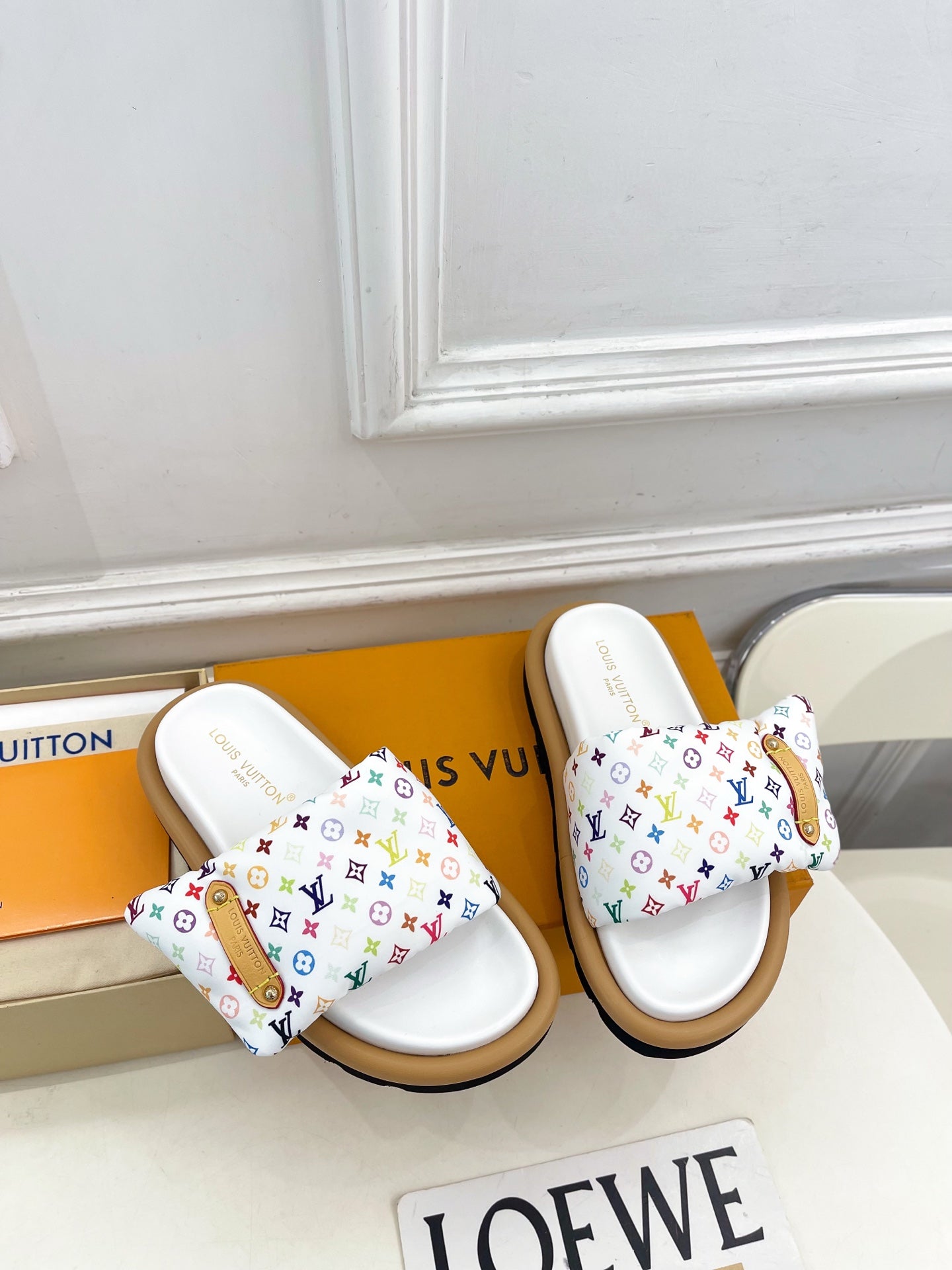 Logo slide sandals with white footbed and multicolor patterned straps, tan sole