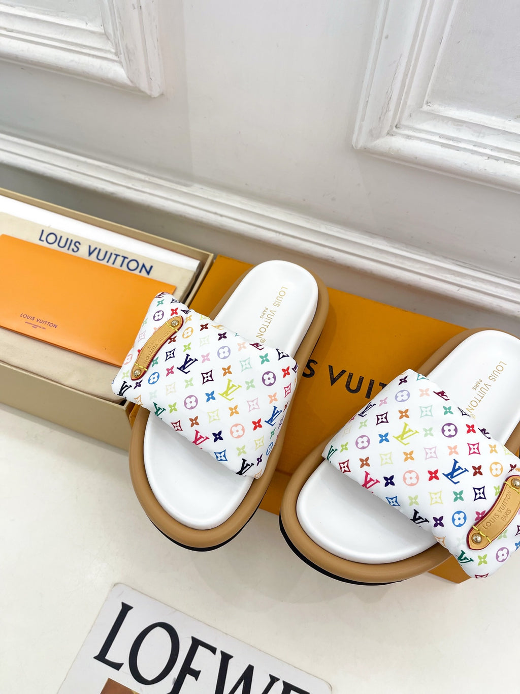 Logo slide sandals, pair view with white straps and multicolor monogram pattern