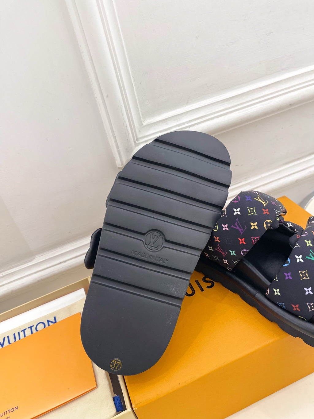 Luxury slide sandal outsole and strap; dark sole with tread, navy monogram upper