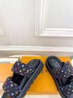 Luxury slide sandals, close tops; dark navy monogram print straps with multicolor details
