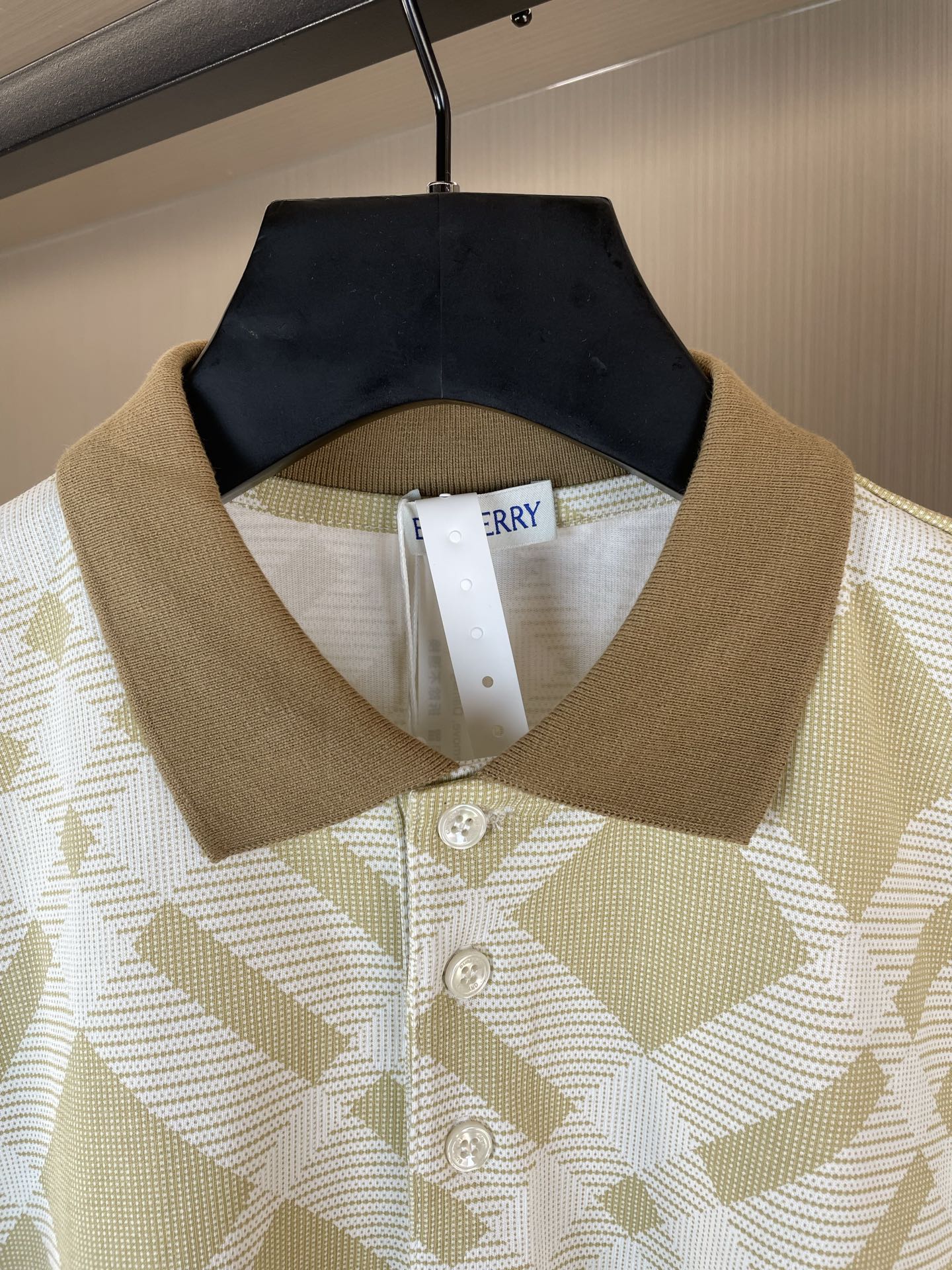 Polo shirt with folded collar and button placket, yellow-and-white check pattern