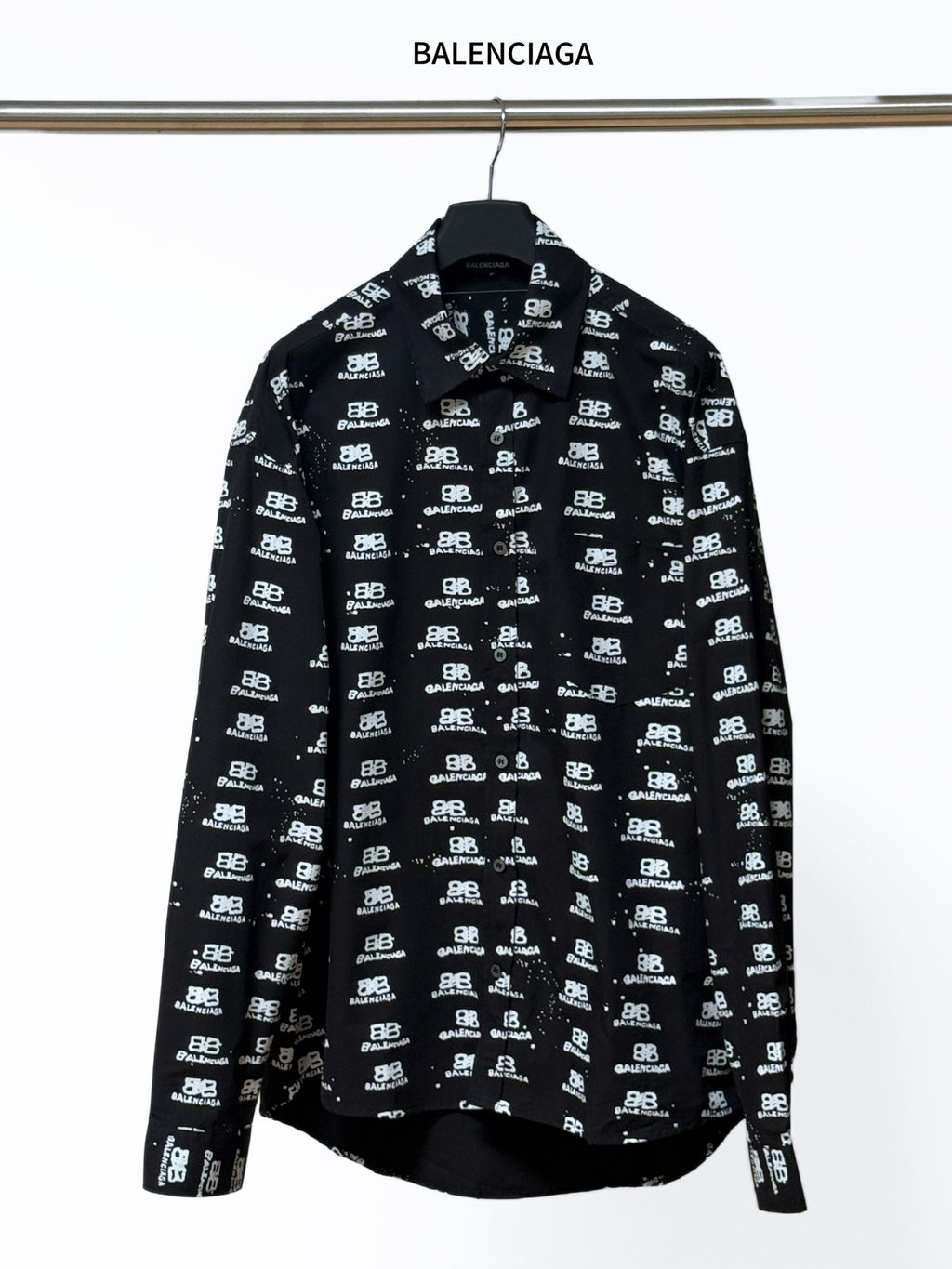 Black long-sleeve shirt with Balenciaga logo repeat, button-up collar.
