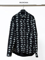 Black long-sleeve shirt with Balenciaga logo repeat, button-up collar.