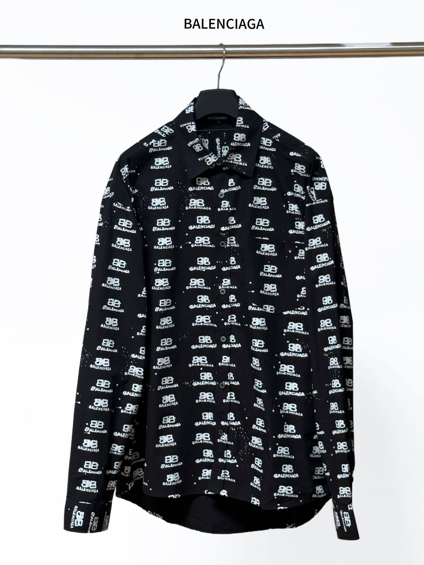 Black long-sleeve shirt with Balenciaga logo repeat, button-up collar.
