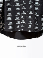 Black long-sleeve shirt hem with Balenciaga logo repeat and solid underside.