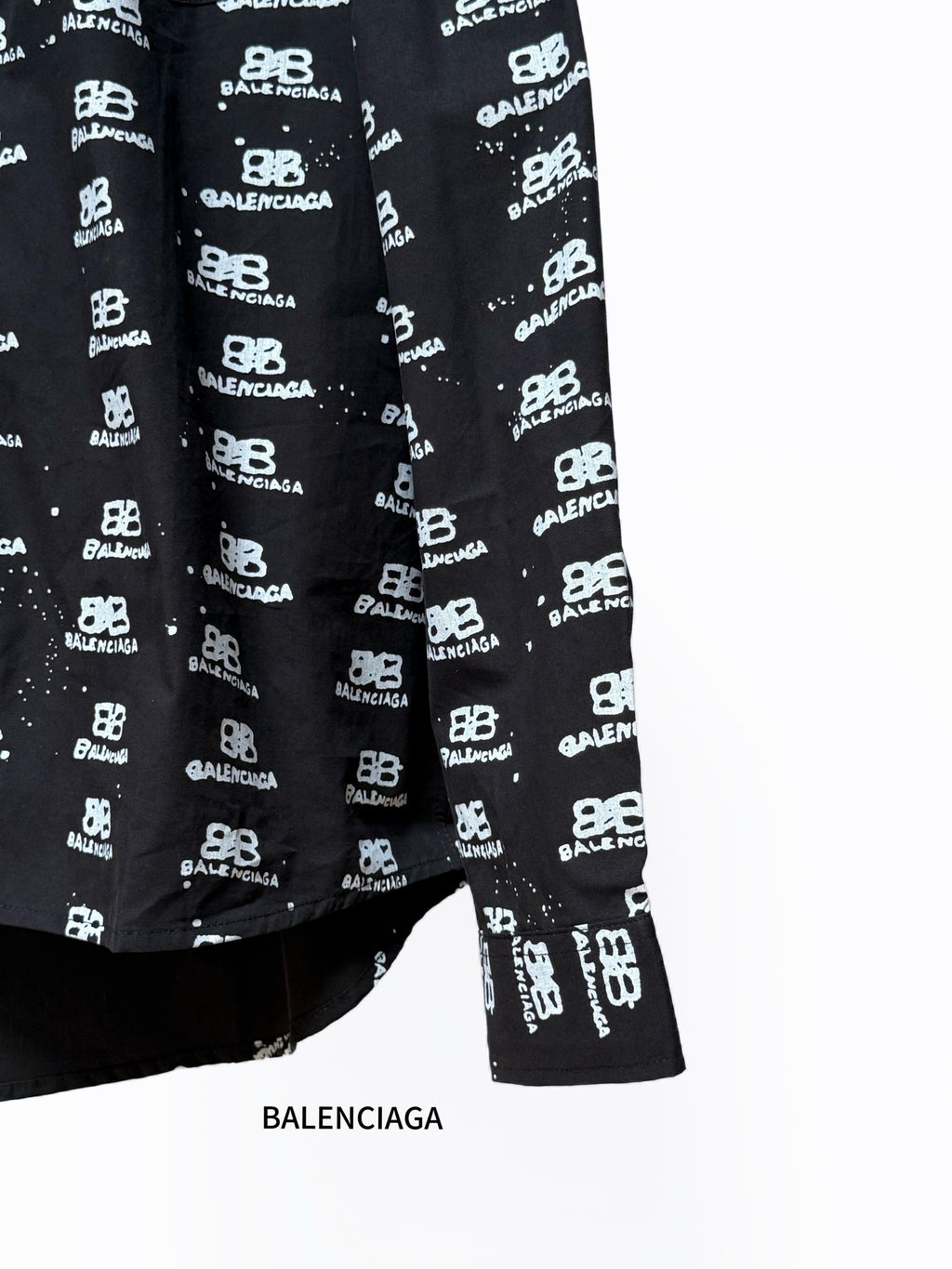 Black long-sleeve shirt with Balenciaga logo repeat, lower front and hem.