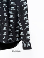 Black long-sleeve shirt with Balenciaga logo repeat, lower front and hem.