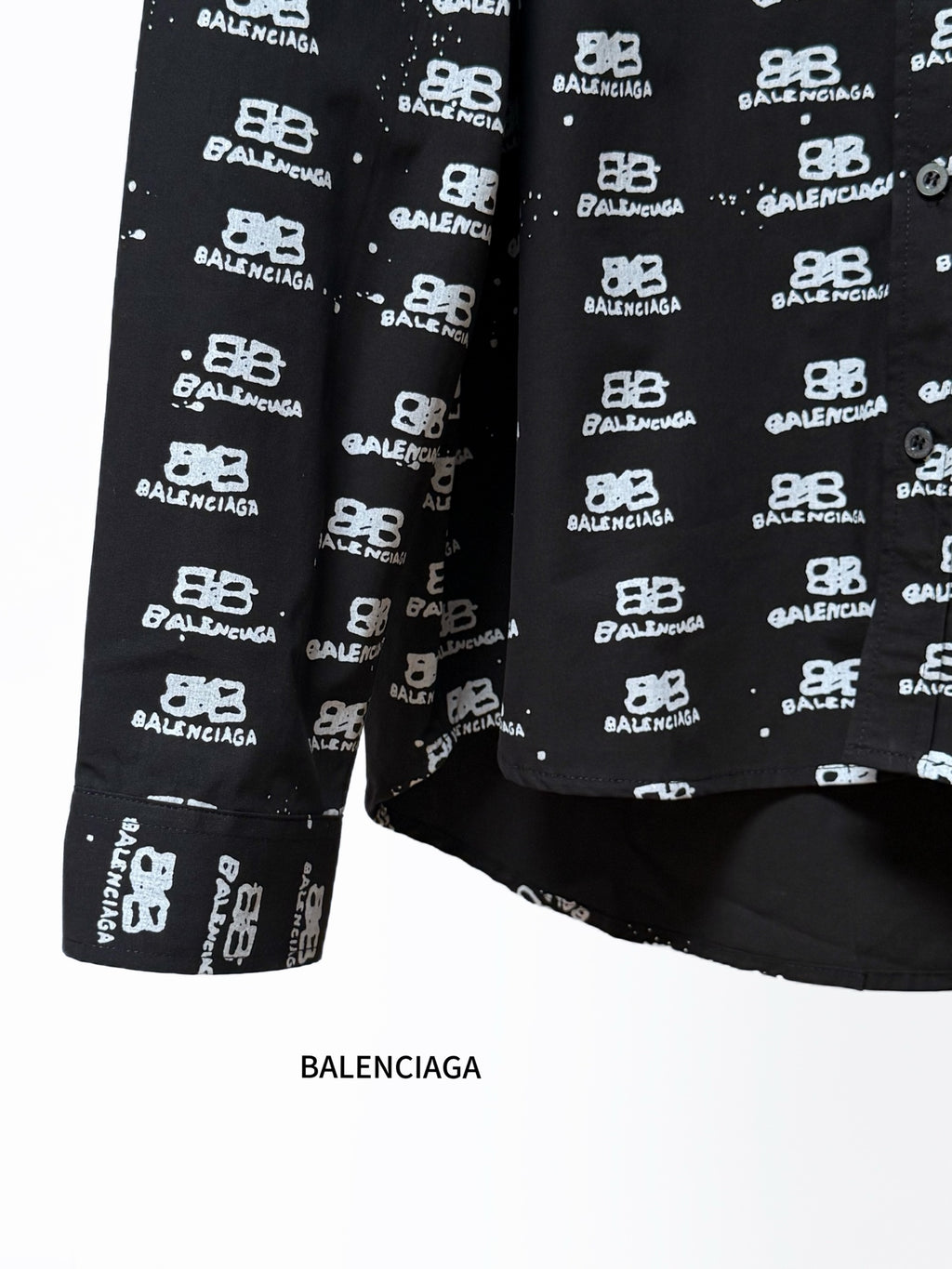 Black long-sleeve shirt with Balenciaga logo repeat, hem and sleeve detail.