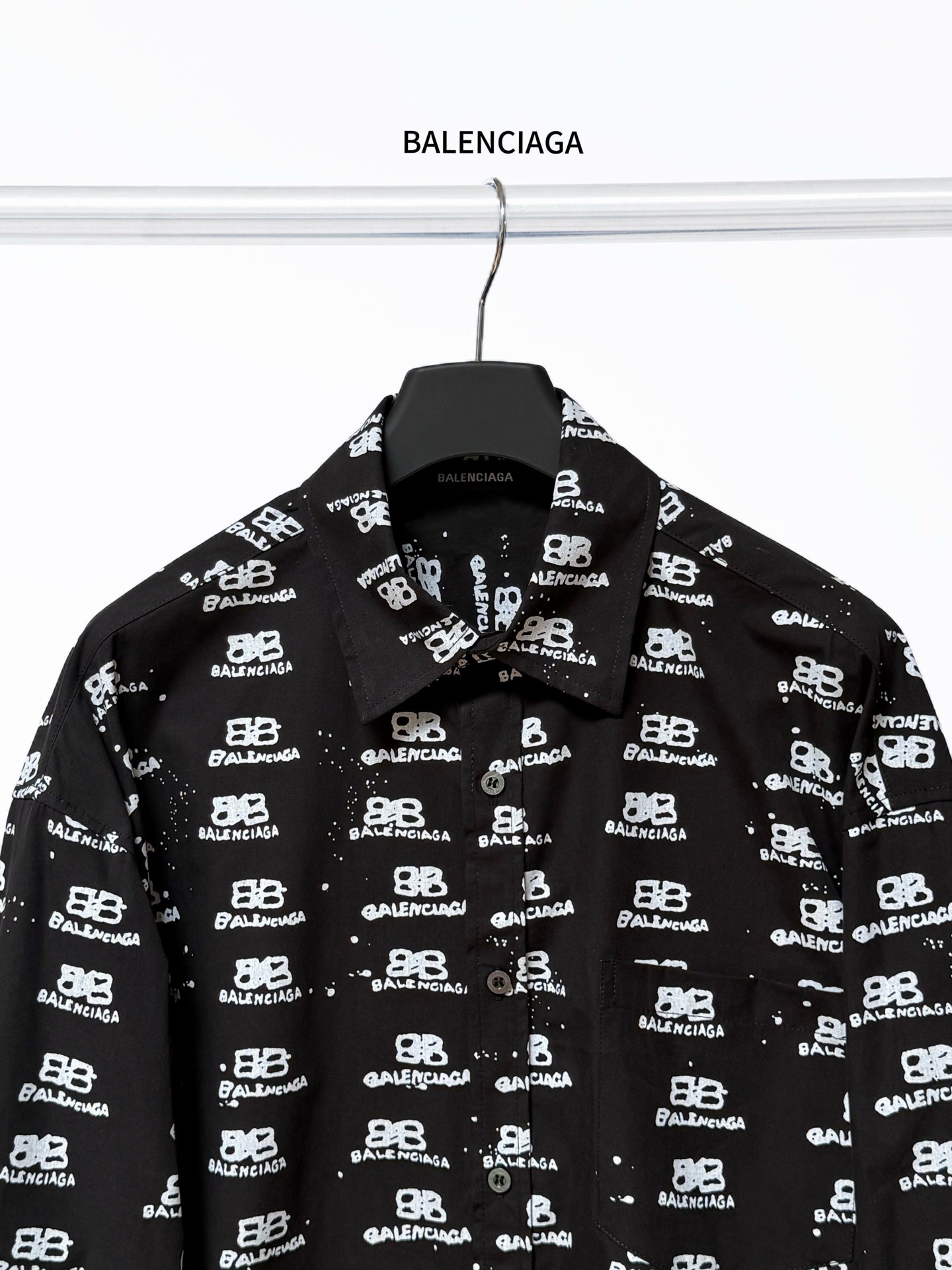 Black long-sleeve button-up shirt with Balenciaga logo repeat, full front view.