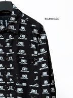 Black long-sleeve shirt sleeve with Balenciaga logo repeat, cuff detail.