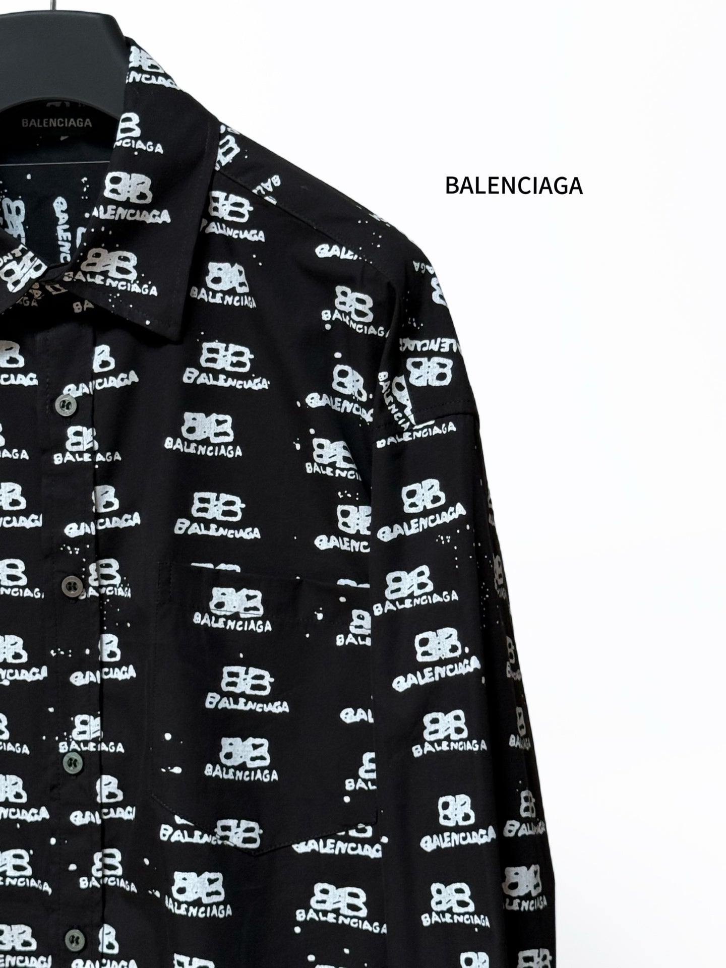 Black long-sleeve shirt sleeve with Balenciaga logo repeat, cuff detail.