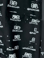 Black front pocket on shirt with Balenciaga logo repeat, close-up.
