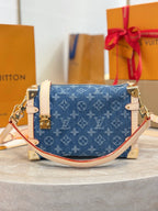 Louis Vuitton bag in blue monogram canvas with white trim, gold hardware, front view