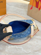 Louis Vuitton bag interior view with blue lining and zip pocket, open top
