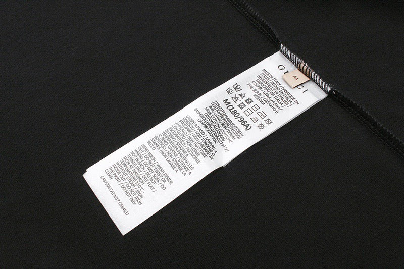 Black T-shirt with care label and barcode tag inside collar