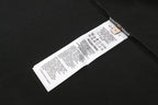 Black T-shirt with care label and barcode tag inside collar