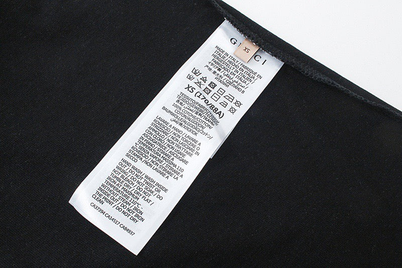 Black T-shirt interior with white Gucci size and care label