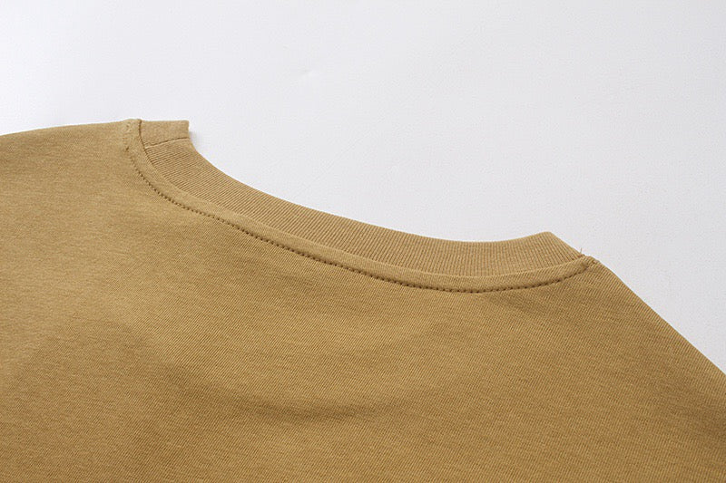 Tan crew-neck T-shirt with ribbed collar close-up