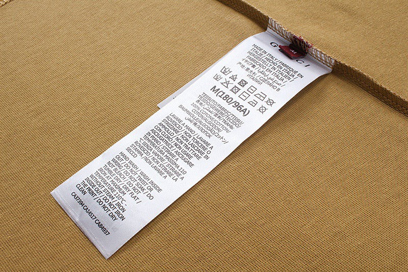 Tan T-shirt inside care label tag near collar