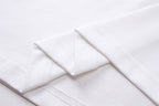 White T-shirt shoulder seam with visible stitching and folded fabric