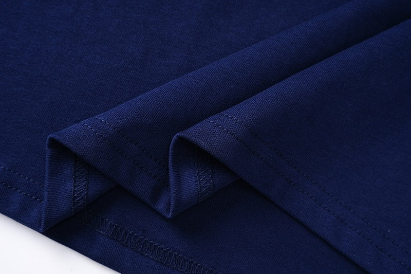 Navy T-shirt fabric close-up with seam stitching