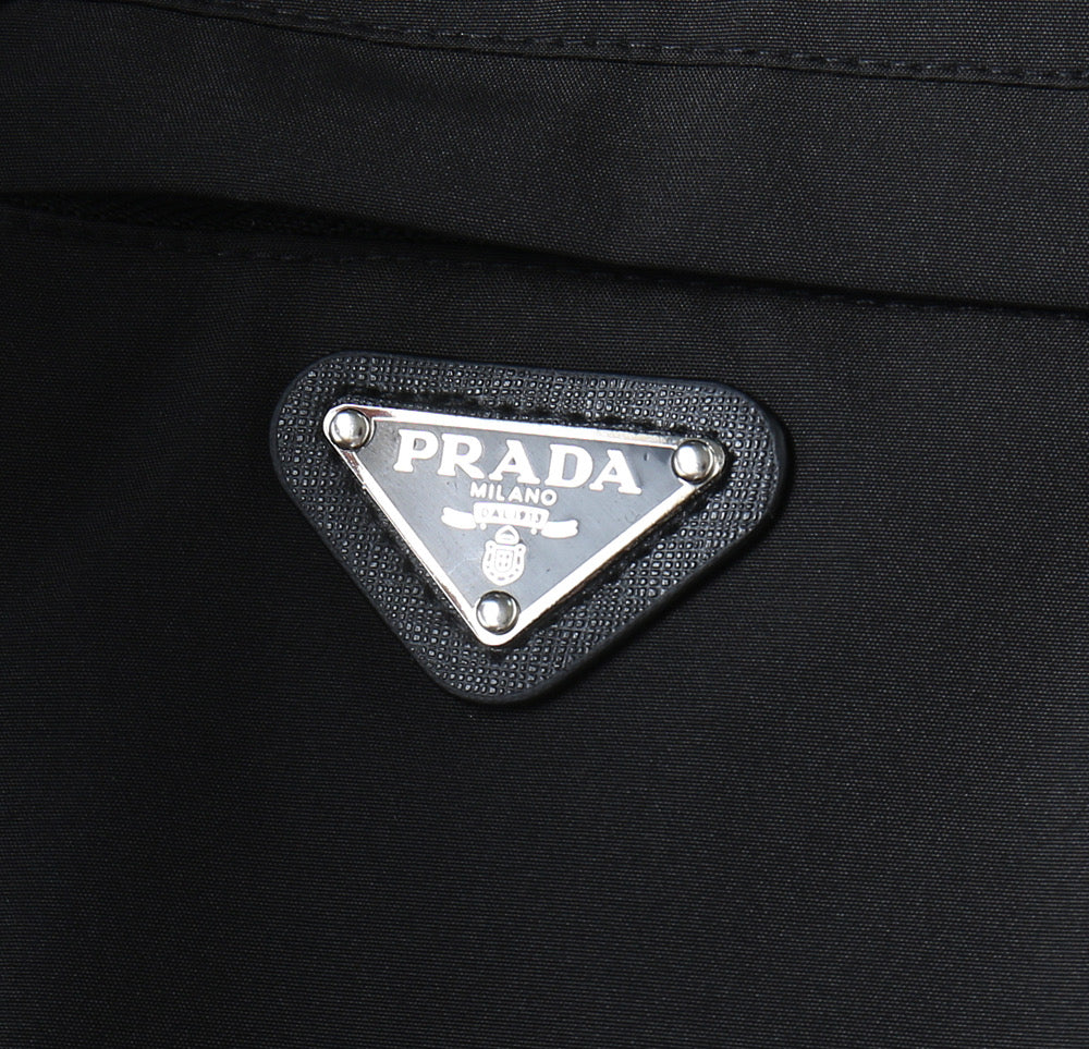 Prada logo patch on dark jacket chest pocket