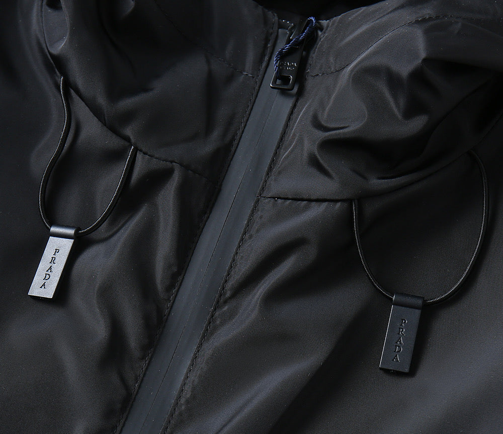 Prada black zip jacket close-up with drawstring pull tags