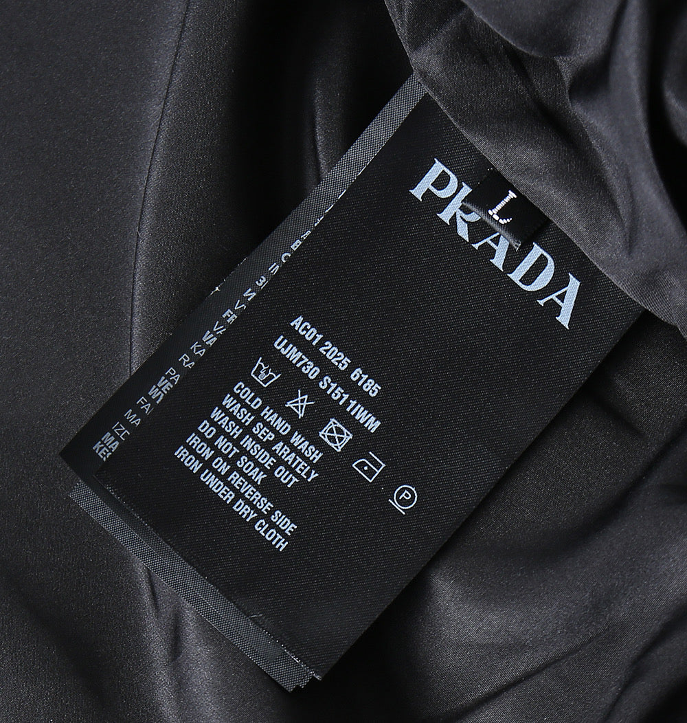 Prada care label on black fabric with brand name and washing instructions