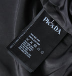Prada care label on black fabric with brand name and washing instructions