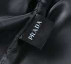 Prada branded fabric label on inside of dark leather jacket