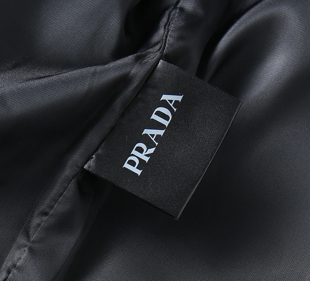 Prada branded fabric label on inside of dark leather jacket