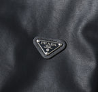 Prada logo patch on dark leather jacket front triangle emblem
