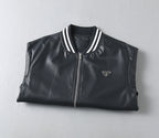 Black leather jacket with front zipper, striped rib collar, and triangular logo patch
