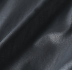 Black leather jacket fabric close-up with fine grain texture