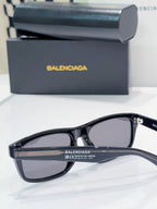 Sunglasses with black frame and dark lenses, side close-up