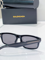 Sunglasses with black frame and dark lenses, front close-up