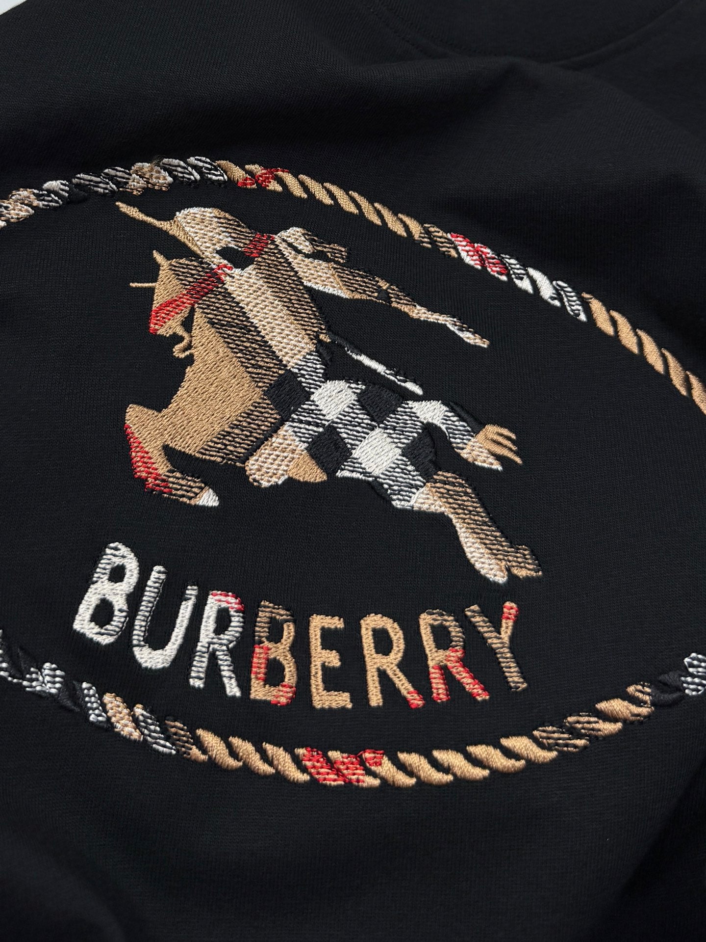 Black short-sleeve T-shirt with plaid horse logo and "BURBERRY" print