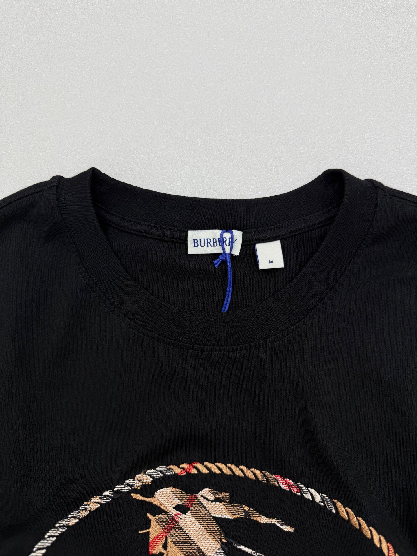 Black crewneck T-shirt neckline with inner Burberry label