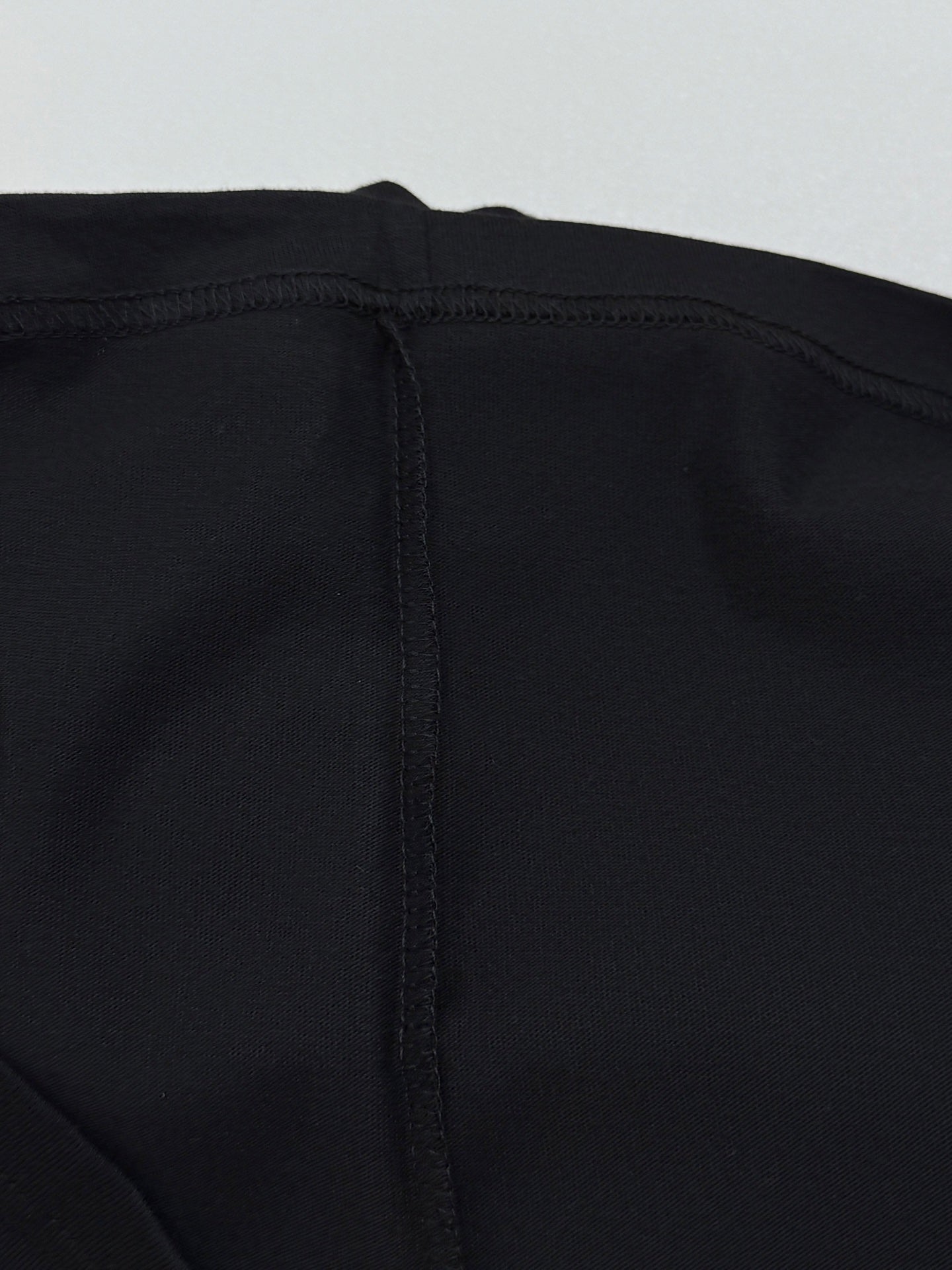 Black T-shirt back yoke seam with center stitched panel