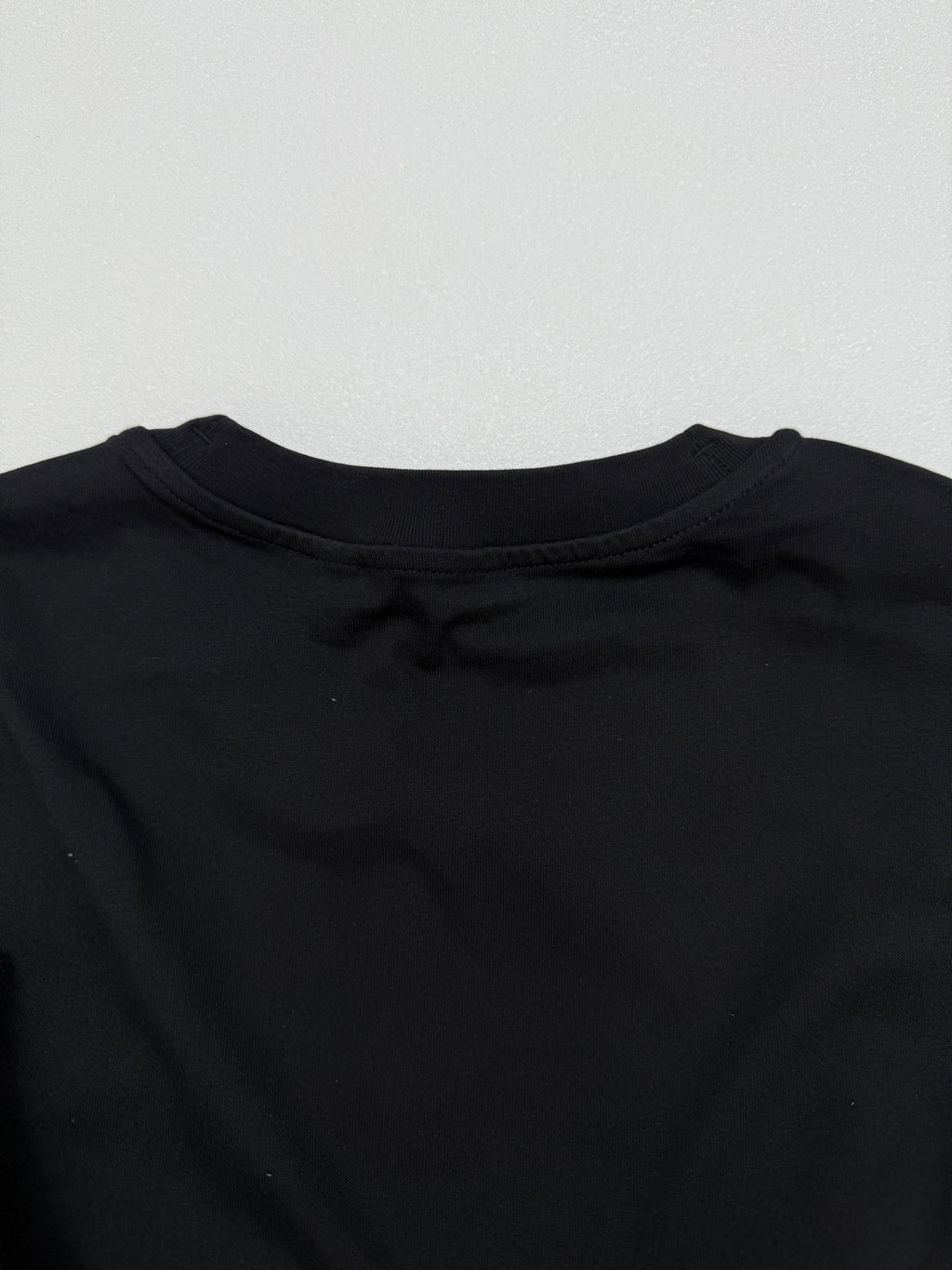 Black short-sleeve T-shirt back neckline with crew collar stitching