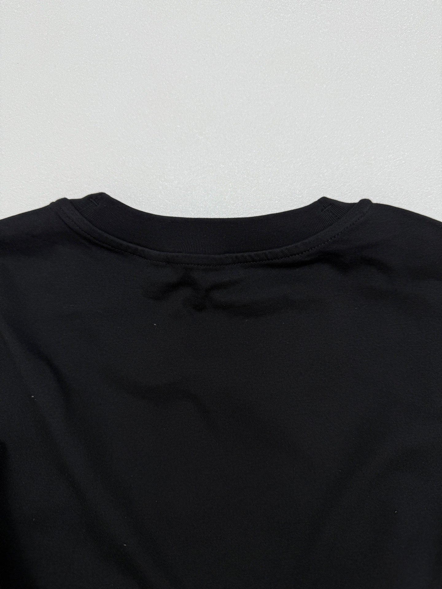 Black short-sleeve T-shirt back neckline with crew collar stitching